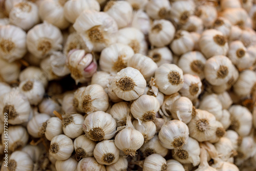 A close-up stock photo of garlic bulbs, with their papery white skin.
