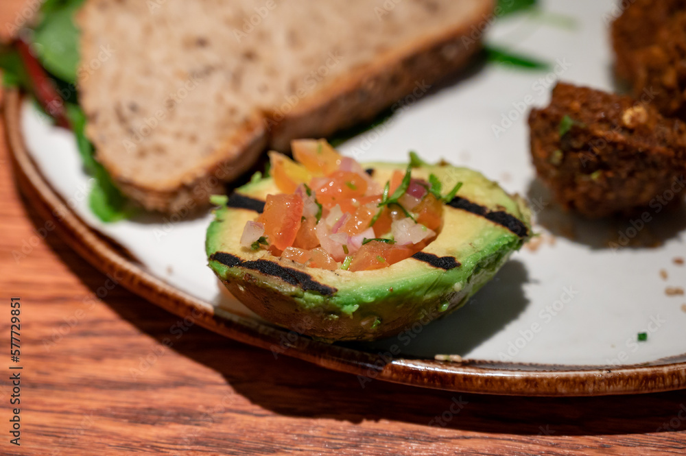 Healthy vegetarian food, vegan falafel balls served with grilles baked eggplant and grilled avocado Healthy vegetarian food, vegan falafel balls served with grilles baked eggplant and grilled avocado