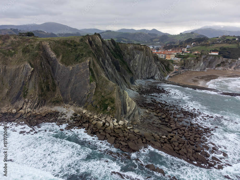 View on steeply-tilted layers of flysch geological formation on Atlantic coast at Zumaia, Basque Country, Spain View on steeply-tilted layers of flysch geological formation on Atlantic coast at Zumaia, Basque Country, Spain