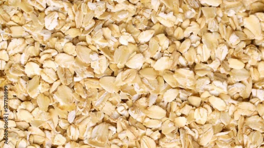 Bunting as background with place for text. Oatmeal for diet food. Organic diet oatmeal for a healthy diet. Macro, rotation. Slow motion. Bunting as background with place for text. Oatmeal for diet food. Organic diet oatmeal for a healthy diet. Macro, rotation. Slow motion.