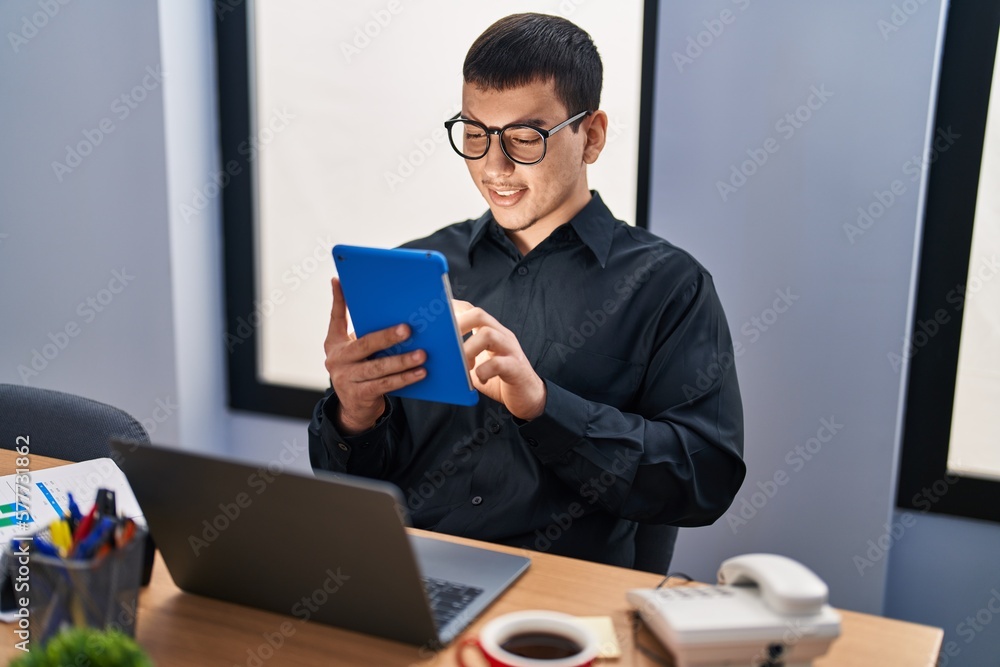 Young man business worker using laptop and touchpad at office