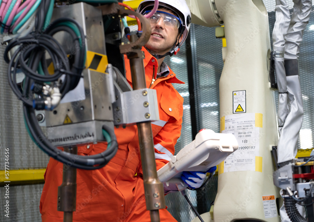 Robotic engineer examining robot power gear machine for repairing service. Modern technology technician working on hardware maintenance to repair steel and metal part of industrial automated equipment Robotic engineer examining robot power gear machine for repairing service. Modern technology technician working on hardware maintenance to repair steel and metal part of industrial automated equipment