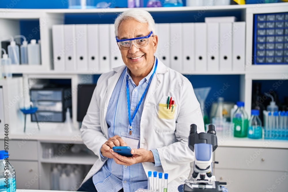 Senior man scientist using smartphone at laboratory Senior man scientist using smartphone at laboratory