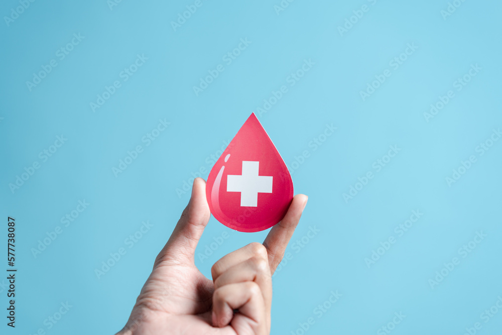 hands holding blood drop paper cut, blood transfusion, world blood donor day, red cross to give blood.world hemophilia day concept.. hands holding blood drop paper cut, blood transfusion, world blood donor day, red cross to give blood.world hemophilia day concept..