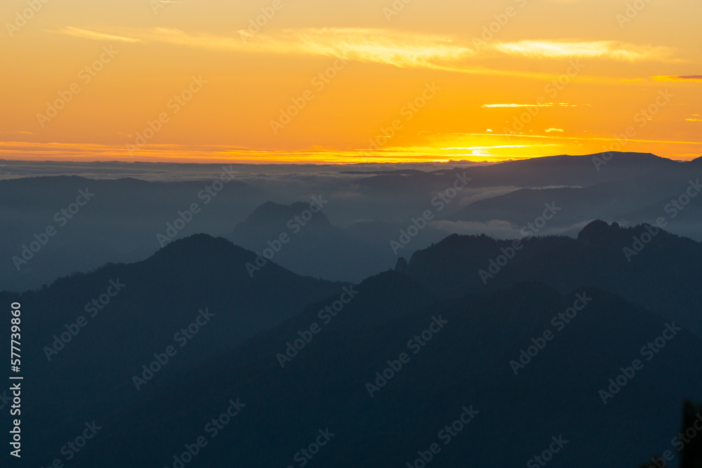 Sunset mountain fog landscape background in Cozia National Park in autumn that inspires calm and peace