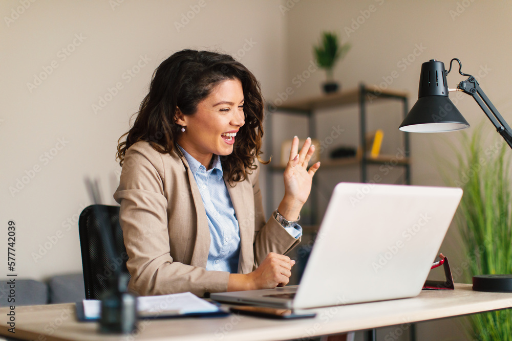 Young business woman having conference video call via laptop at office Young business woman having conference video call via laptop at office