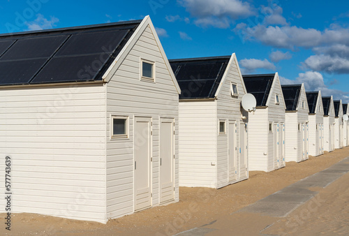 Row of white wooden beach houses with solar panels at seaside resort Katwijk aan Zee photo