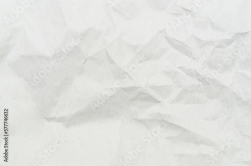 Wrinkled or crumpled white stencil paper or tissue after use in toilet or restroom with large copy space used for background texture in decorative art work
