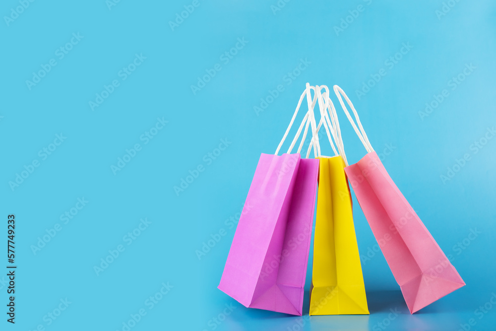shopping bags on blue background, purchase shopper, sale and discount, copy space