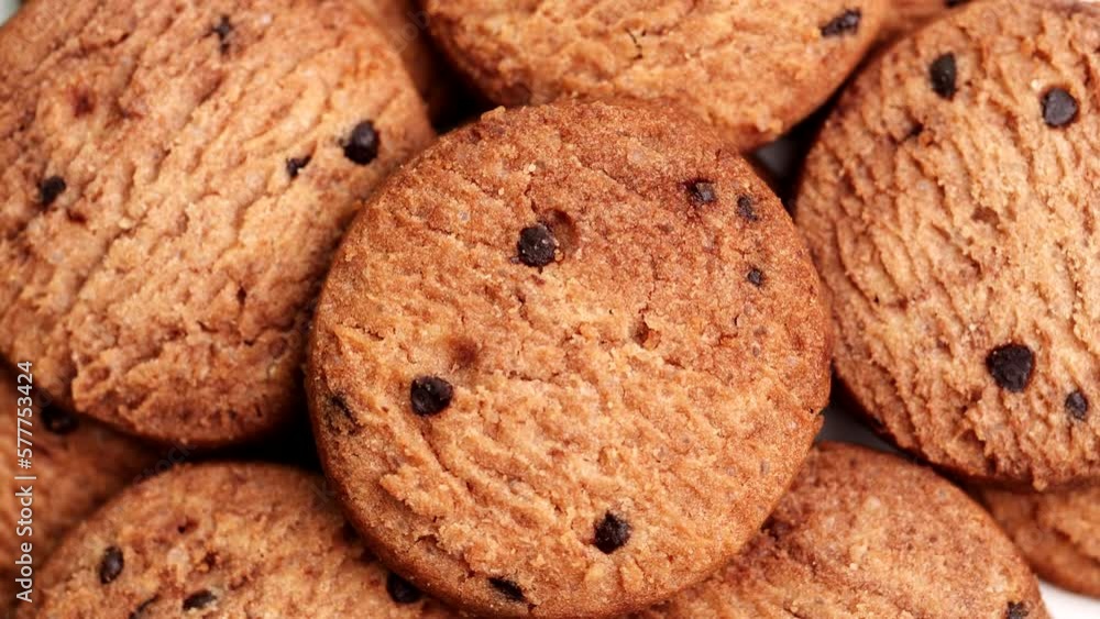 Homemade Cookies top view, extreme close-up Cookies, Chocolate chip cookies rotating on table, slow motion. Concept of Dessert, Snack, Biscuit, Chocolate Cookies, Bakery, American Food, Unhealthy Food Homemade Cookies top view, extreme close-up Cookies, Chocolate chip cookies rotating on table, slow motion. Concept of Dessert, Snack, Biscuit, Chocolate Cookies, Bakery, American Food, Unhealthy Food