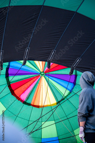 Colorful hot air balloon, view from inside of balloon and person standing next to it