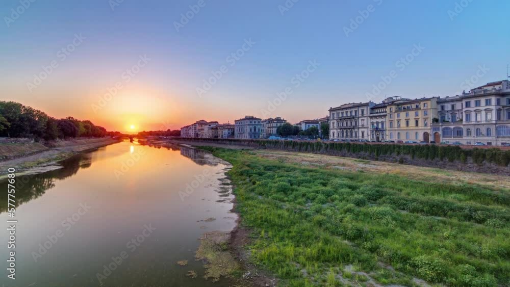 Sunset skyline view of Florence City, housing, buildings and Arno River. Colorful sky in Italy. View from Ponte Amerigo Vespucci bridge with reflections on water Sunset skyline view of Florence City, housing, buildings and Arno River. Colorful sky in Italy. View from Ponte Amerigo Vespucci bridge with reflections on water