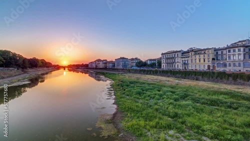 Wallpaper Mural Sunset skyline view of Florence City, housing, buildings and Arno River. Colorful sky in Italy. View from Ponte Amerigo Vespucci bridge with reflections on water Torontodigital.ca