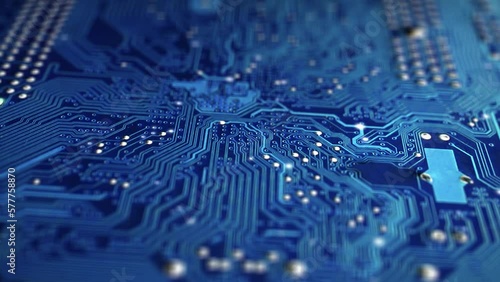 Animation electronic signal move and flash along the surface tracks of the blue circuit board. Motherboard close up. Motion design, animated computer graphics of a computer or microchip.