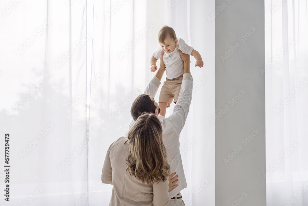 Cheerful Happy Family Of Three Having Fun Together At Home Cheerful Happy Family Of Three Having Fun Together At Home