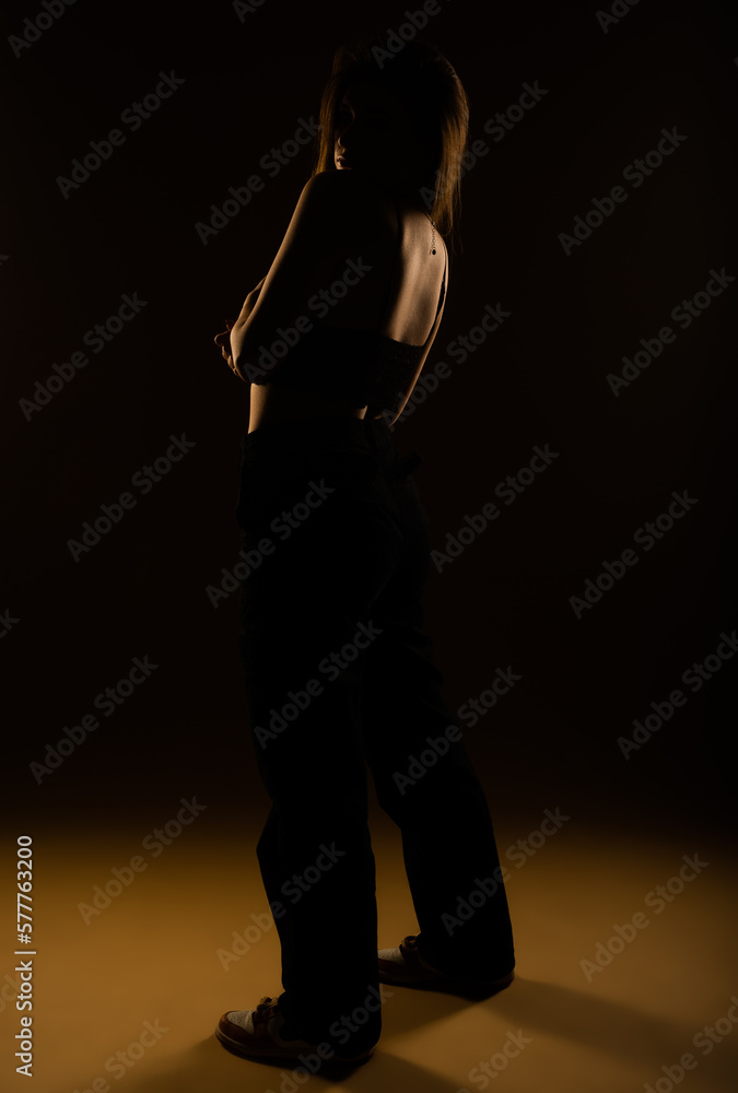 An attractive young girl looking back over her shoulder. Studio shoot