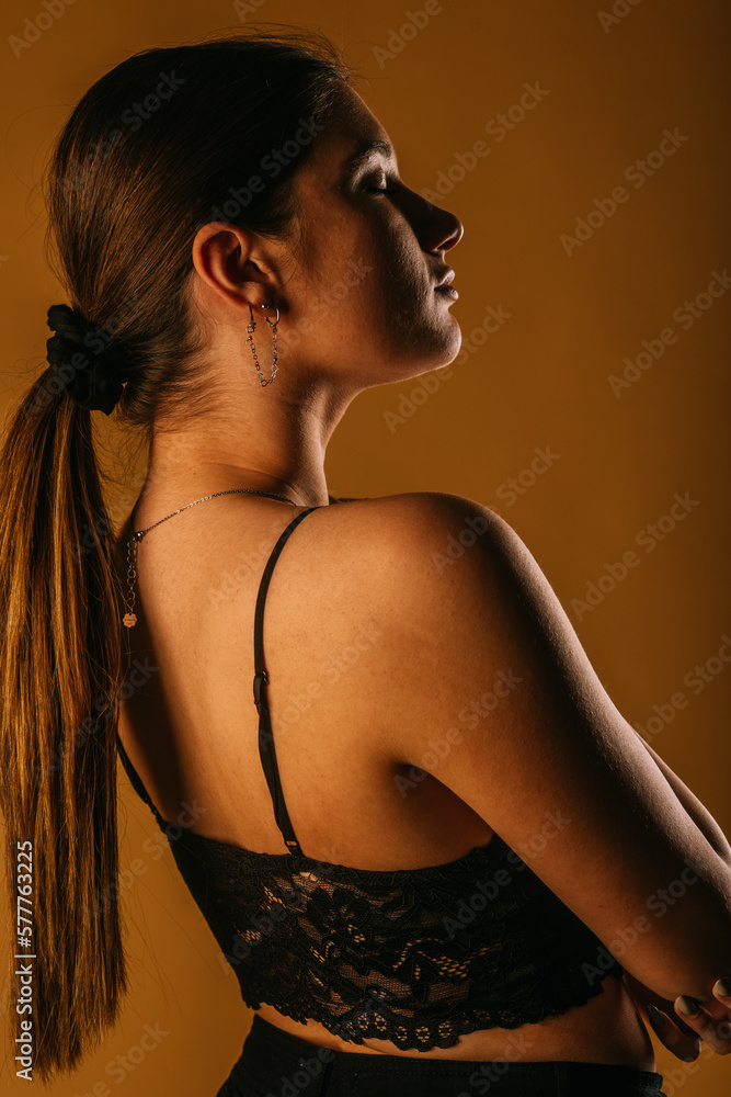 Naklejka premium Girl posing with closed eyes. Close up. Side view