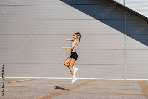 Girl jumping and looking aside