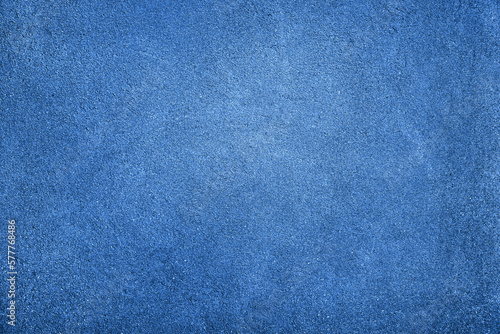 Blue abstract texture background with space for design. Painted rough concrete wall surface. Close-up. Empty.