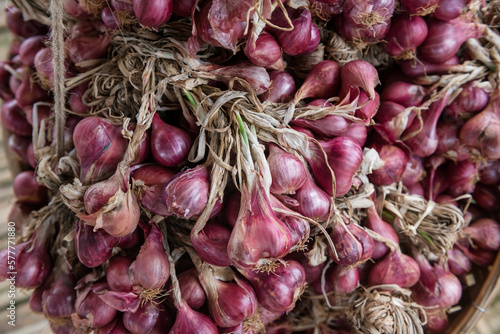 Top view of shallots aka red onion on basket for sell in Thai market