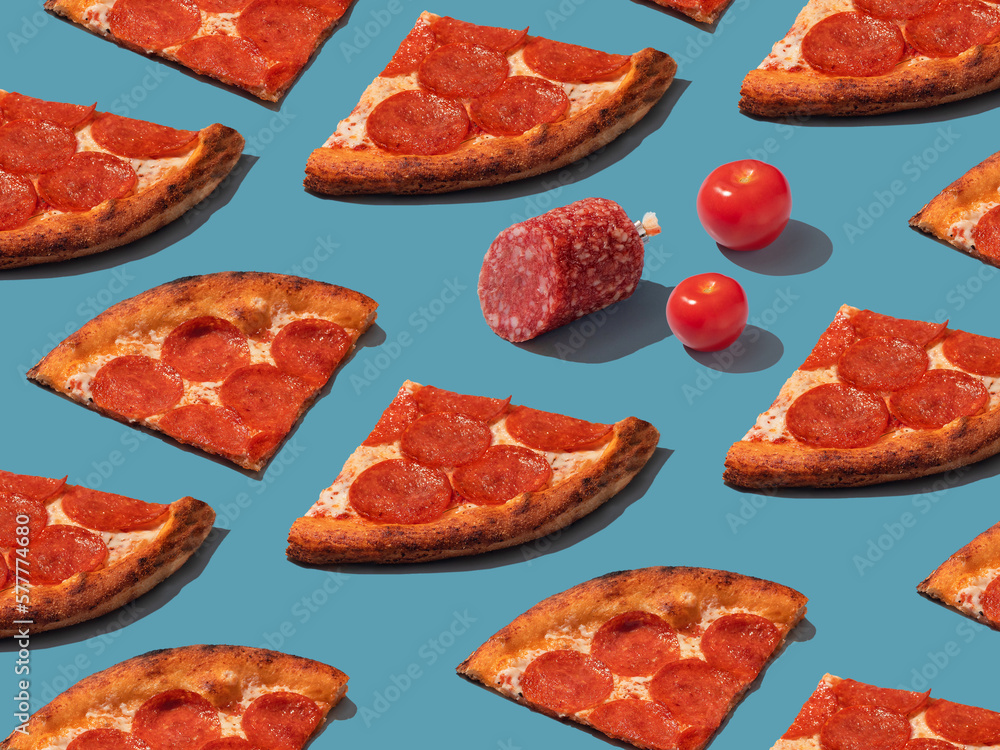 Pepperoni slice pizza with salami and tomatoes pattern. Food pattern with hard shadows Pepperoni slice pizza with salami and tomatoes pattern. Food pattern with hard shadows