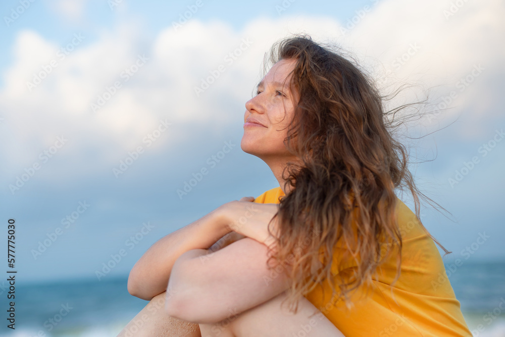 Naklejka premium Portrait of happy girl, young carefree woman enjoying summer vacation on sea, walking on beach sand, smiling and having fun in tropical country, relaxing on nature. Summertime, happiness concept.