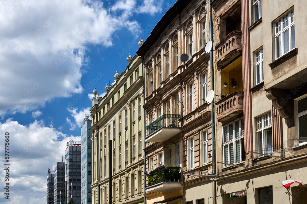 facades of historic tenement houses and modern office buildings in the city of Poznan