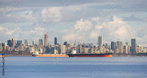 Ships and Vancouver Downtown Skyline on West Coast of Pacific Ocean. British Columbia, Canada. Cloudy Sunset.