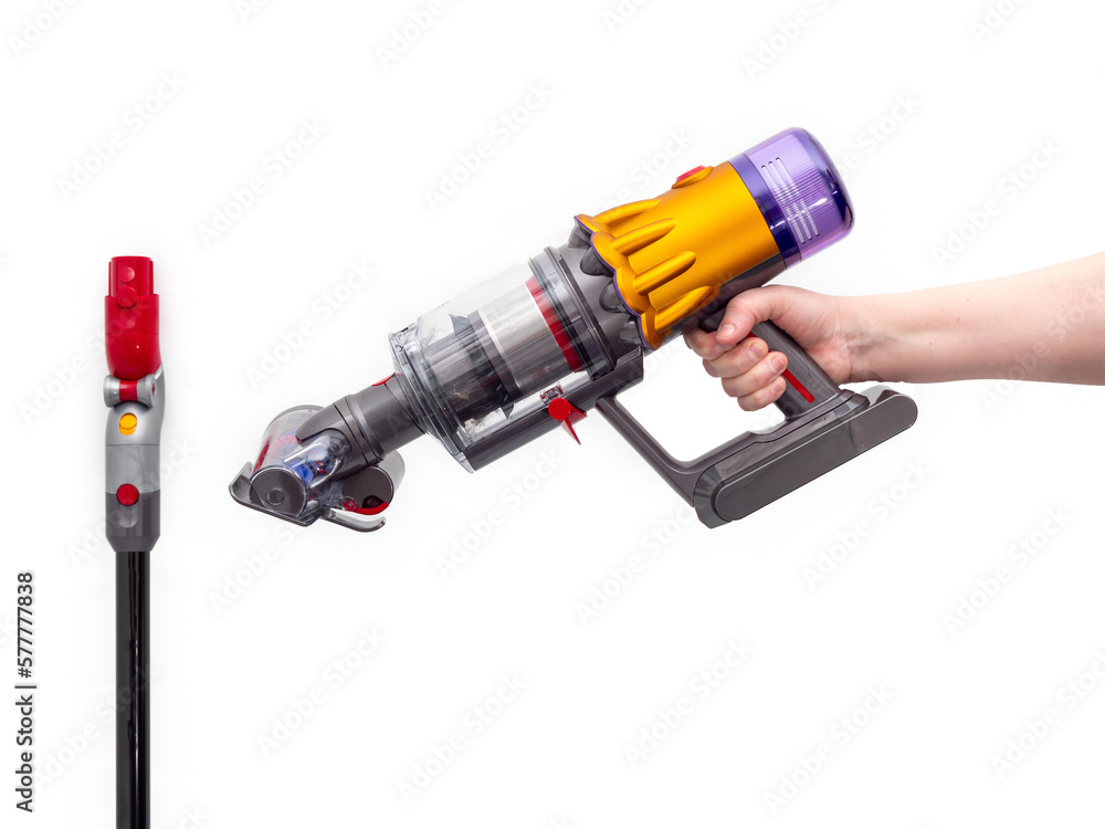 Woman's hand holds Modern cordless vacuum cleaner isolated on white background. New technologies. Woman's hand holds Modern cordless vacuum cleaner isolated on white background. New technologies.