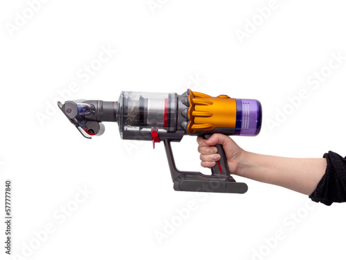 Woman's hand holds Modern cordless vacuum cleaner isolated on white background. New technologies.