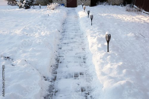 Freshly fallen snow cleared from the front of the house photo