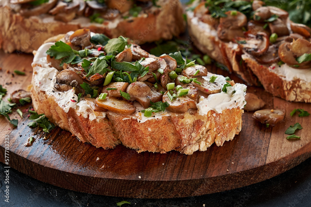 Close-up of appetizing bruschetta cream cheese and fried champignon mushrooms. Close-up of appetizing bruschetta cream cheese and fried champignon mushrooms.