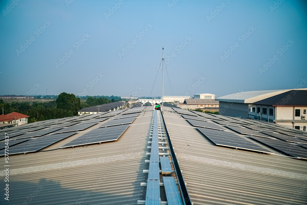 Solar panels on factory roof photovoltaic solar panels absorb sunlight as a source of energy to generate electricity creating sustainable energy