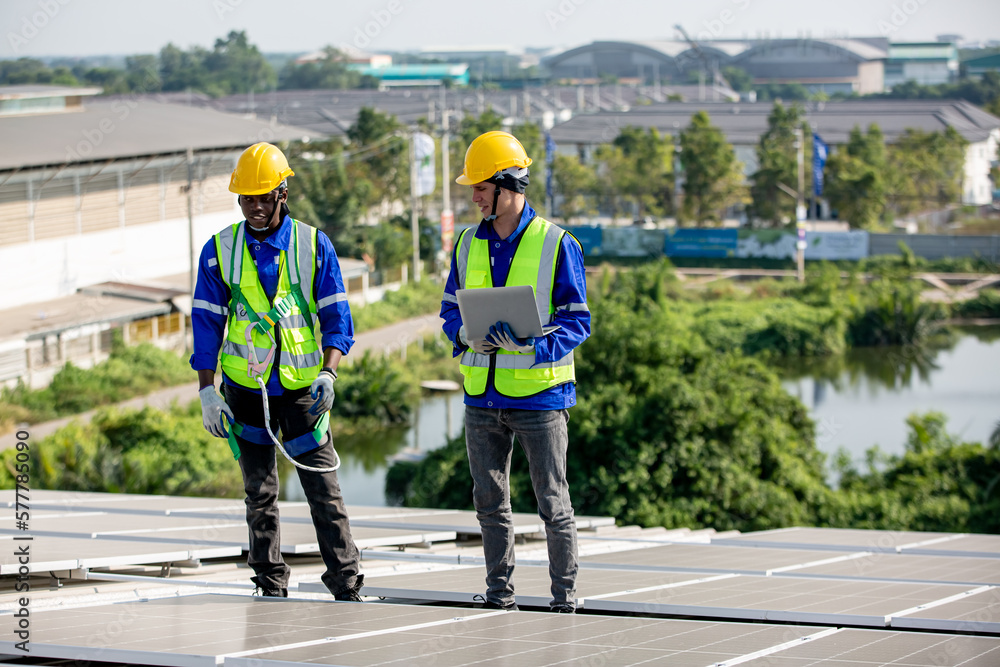 Engineer service check installation solar cell on the roof of factory. technician checks the maintenance of the solar panels, engineering team working on checking and maintenance in solar power plant