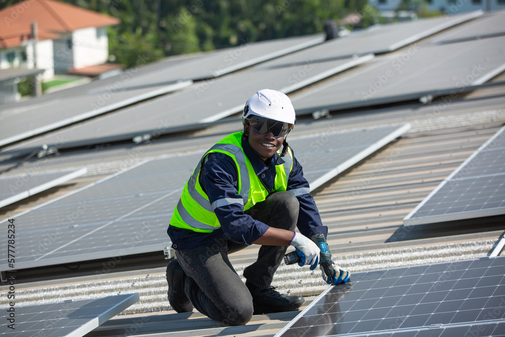 Engineer service check installation solar cell on the roof of factory on the morning. Engineer service check installation solar cell on the roof of factory on the morning.