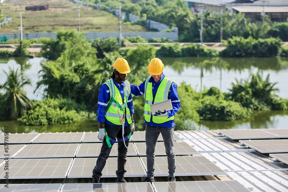 Workers assemble energy system with solar panel for electricity Workers assemble energy system with solar panel for electricity