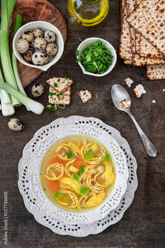 Vegetable broth with egg pancakes and matzo bread. Pesah celebration concept (jewish Passover holiday). 