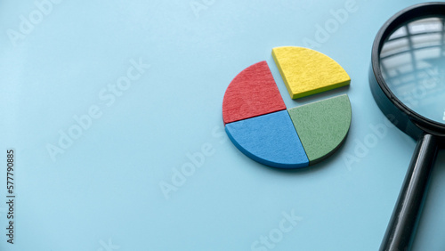 Quarterly report concept.Company financial report.Business charts. Colorful quarter wooden pie chart pieces. Banner with copy space.