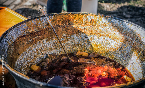 Serbian traditional stew cooked in big pots photo