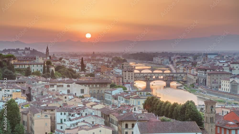 Skyline view of Arno River aerial timelapse from above. Ponte Vecchio from Piazzale Michelangelo at Sunset, Florence, Italy. Colorful sky. Evening mist
