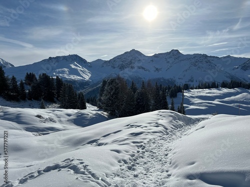 Wonderful winter hiking trails and traces in the fresh alpine snow cover of the Swiss Alps and over the tourist resort of Arosa - Canton of Grisons, Switzerland (Schweiz)