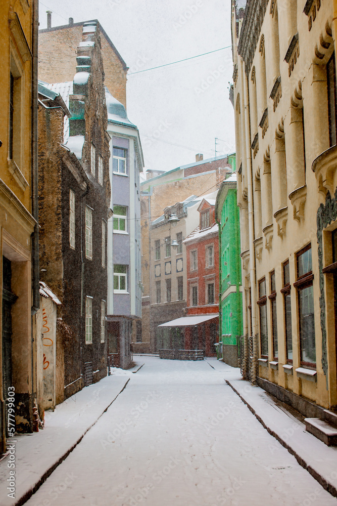 Narrow old town street in Riga, Latvia during heavy snow