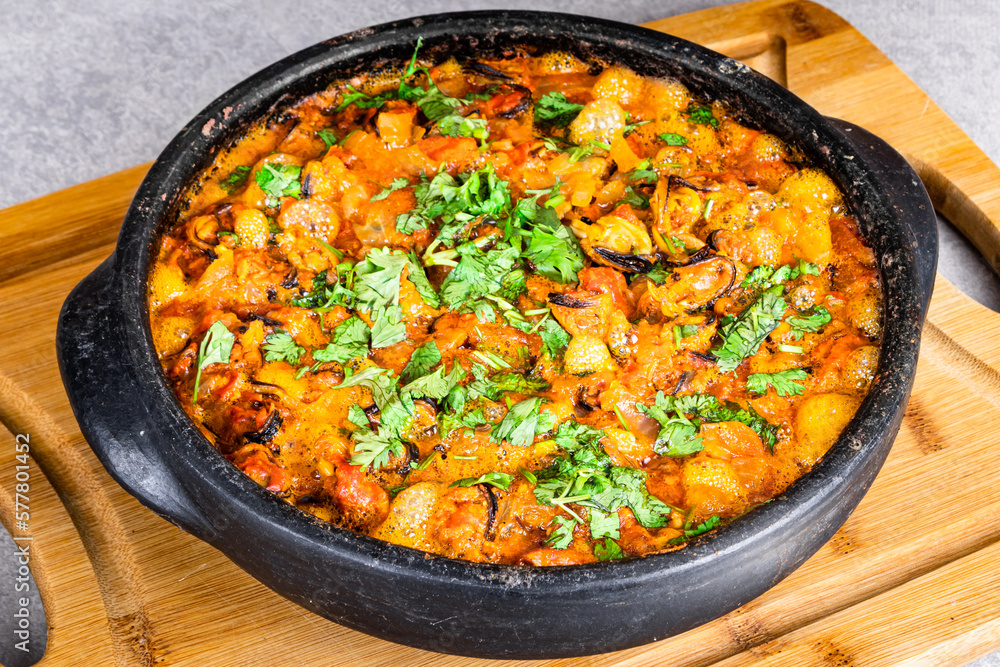 Charru Mussel, known in Brazil as Sururu Moqueca, on wooden board Charru Mussel, known in Brazil as Sururu Moqueca, on wooden board