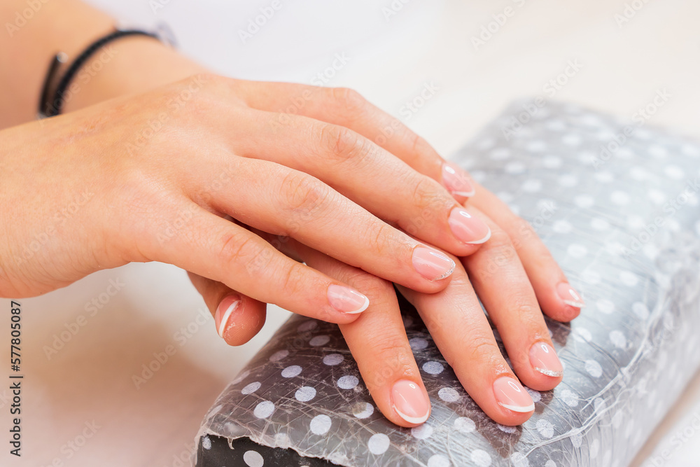 Hands close-up in a beauty salon on a manicure. Background, selective focus