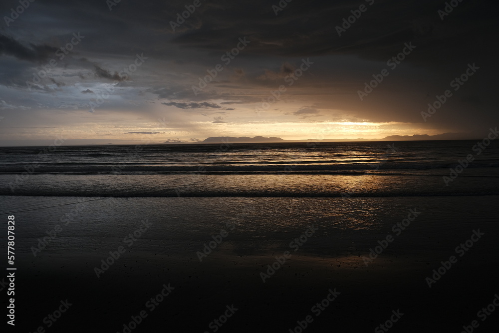 Sunset with moody clouds over the sea