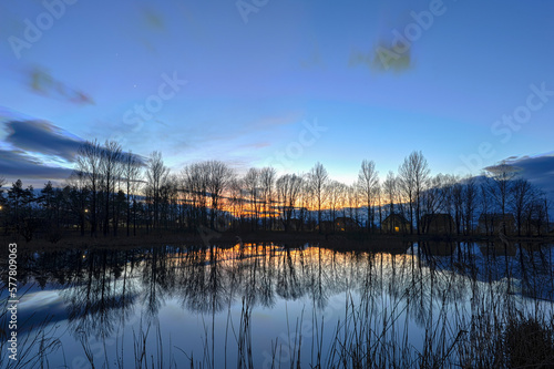Sunrise on the lake, sky and clouds in HDR style