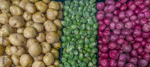 Potatos and Brussels sprouts displayed in a supermarket for sale