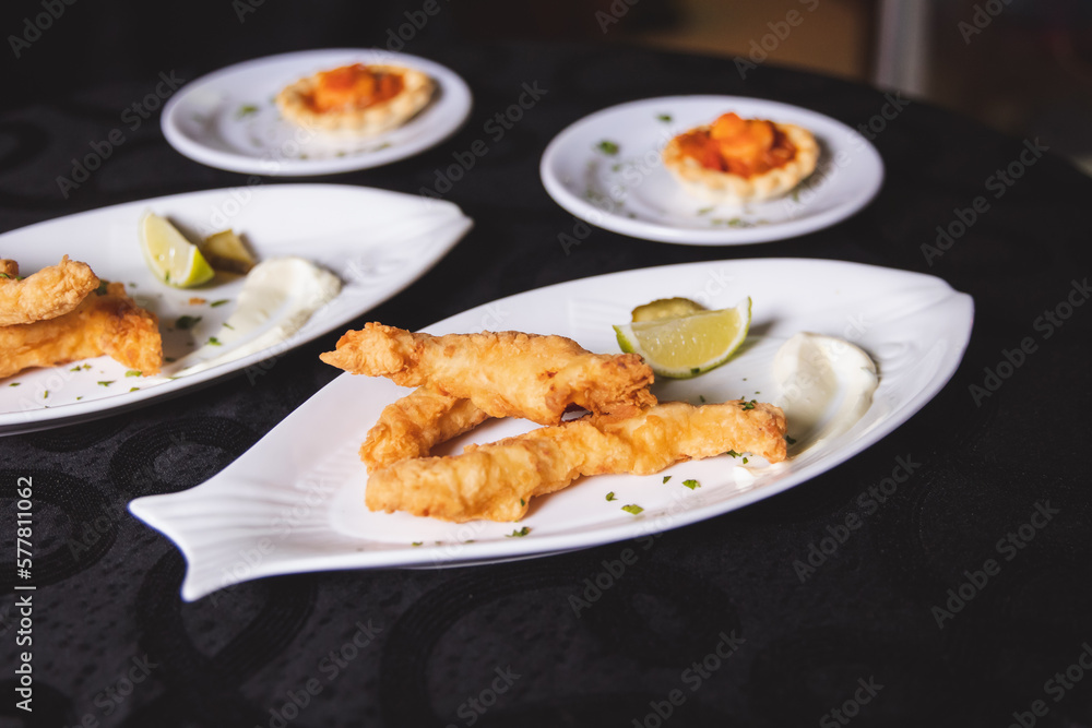 Fried chicken with a piece of lemon served on a plate. Fried chicken with a piece of lemon served on a plate.