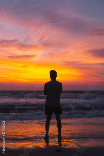 Man at sunset, a brightly colored sunset in Bali.