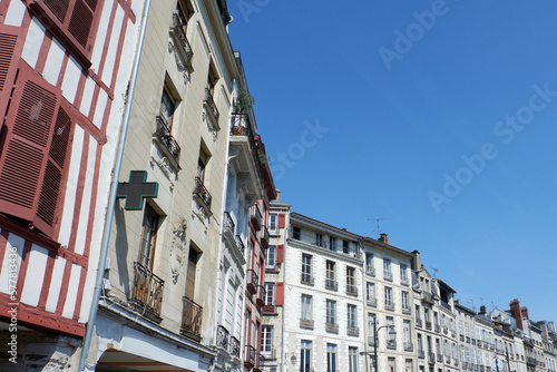 Fototapeta Naklejka Na Ścianę i Meble -  Vintage exteriors of classical french buildings on the river side of Bayonne, France